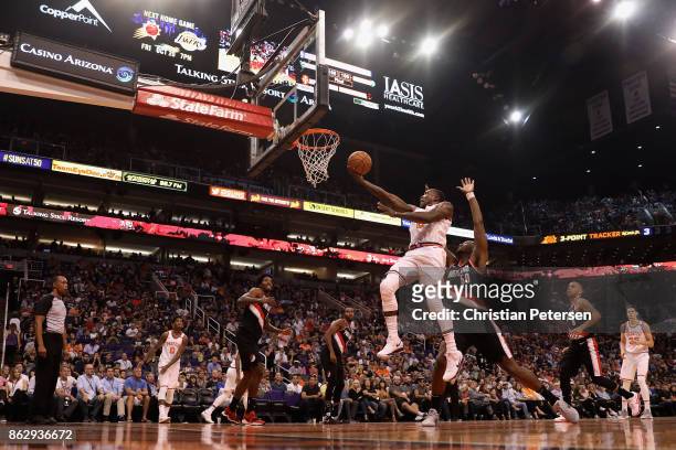 Eric Bledsoe of the Phoenix Suns lays up a shot past Caleb Swanigan of the Portland Trail Blazers during the first half of the NBA game at Talking...