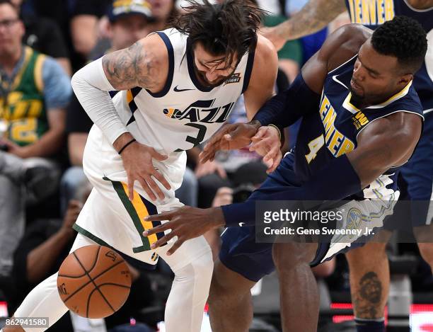 Paul Millsap of the Denver Nuggets knocks the ball away from Ricky Rubio of the Utah Jazz during the second half of the 106-96 win by the Jazz at...