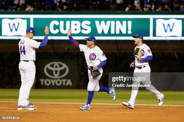 Anthony Rizzo, Jon Jay and Albert Almora Jr. #5 of the Chicago Cubs celebrate defeating the Los Angeles Dodgers 3-2 in game four of the National...