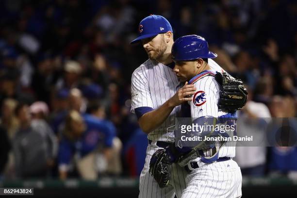 Wade Davis and Willson Contreras of the Chicago Cubs celebrate after beating the Los Angeles Dodgers 3-2 during game four of the National League...