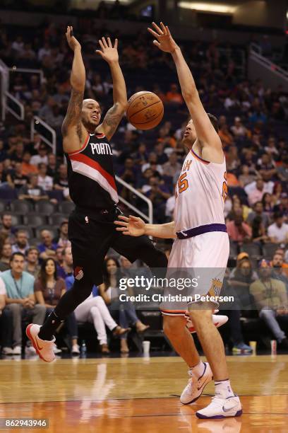 Shabazz Napier of the Portland Trail Blazers looses the ball as he drives against Alec Peters of the Phoenix Suns during the second half of the NBA...