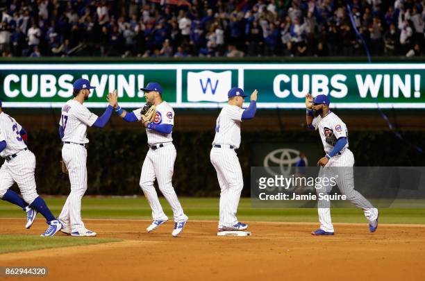 The Chicago Cubs celebrate after beating the Los Angeles Dodgers 3-2 in game four of the National League Championship Series at Wrigley Field on...