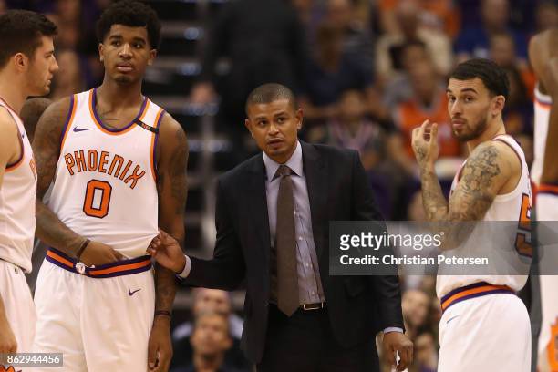 Head coach Earl Watson of the Phoenix Suns talks with Marquese Chriss and Mike James during the second half of the NBA game against the Portland...