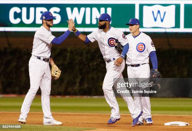 Kris Bryant, Jason Heyward, and Anthony Rizzo of the Chicago Cubs celebrate after beating the Los Angeles Dodgers 3-2 in game four of the National...