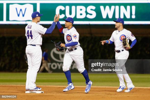 Anthony Rizzo, Jon Jay, and Albert Almora Jr. #5 of the Chicago Cubs celebrate after beating the Los Angeles Dodgers 3-2 in game four of the National...