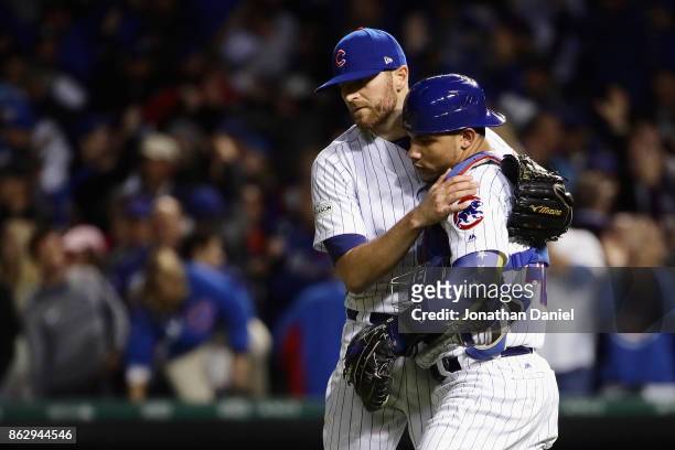 Wade Davis and Willson Contreras of the Chicago Cubs celebrate after beating the Los Angeles Dodgers 3-2 during game four of the National League...
