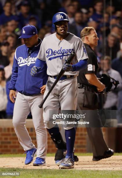 Curtis Granderson and Manager Dave Roberts of the Los Angeles Dodgers walk back to the dugout after Granderson struck out in the eighth inning...