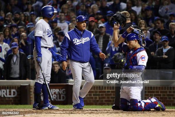 Manager Dave Roberts of the Los Angeles Dodgers argues a call with umpire Jim Wolf in the eighth inning against the Chicago Cubs during game four of...