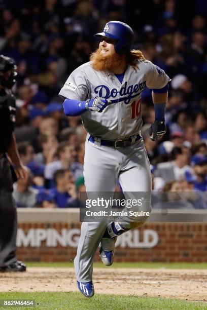 Justin Turner of the Los Angeles Dodgers reacts after hitting a home run in the eighth inning against the Chicago Cubs during game four of the...