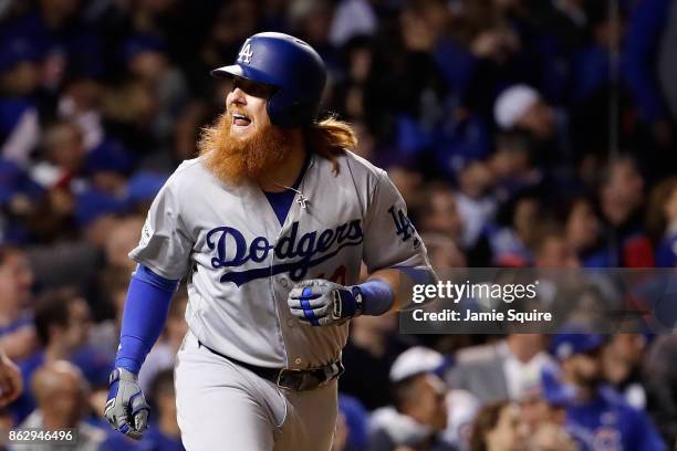 Justin Turner of the Los Angeles Dodgers reacts after hitting a home run in the eighth inning against the Chicago Cubs during game four of the...