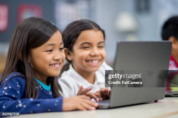 learning about computers - kids reading in classroom stock pictures, royalty-free photos & images