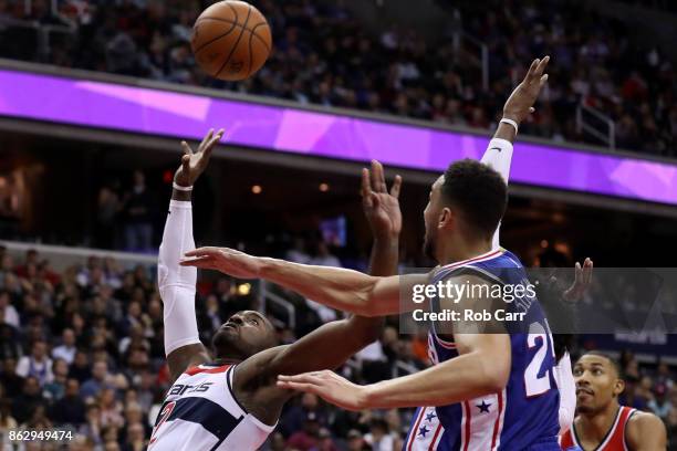 John Wall of the Washington Wizards puts up a shot in front of Ben Simmons of the Philadelphia 76ers at Capital One Arena on October 18, 2017 in...