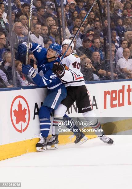 Chicago Blackhawks right wing John Hayden battles along the boards with Toronto Maple Leafs defenseman Nikita Zaitsev in the first period during the...