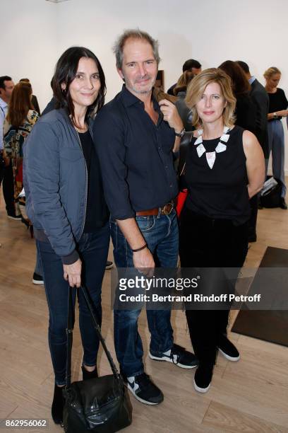 Director Christopher Thompson standing between his wife actress Geraldine Pailhas and his sister Caroline Thompson attend the FIAC 2017 -...