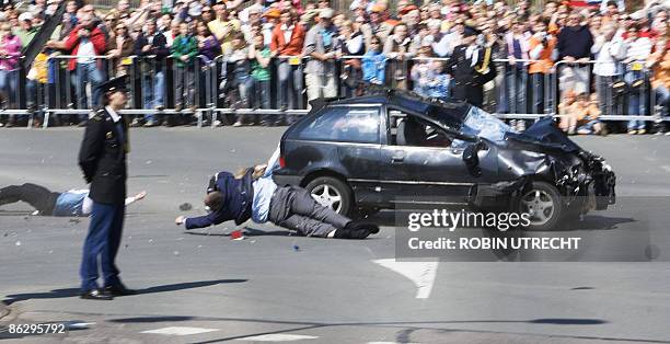 Car crashes into the crowd waiting for the visit of the royal family in Apeldoorn on April 30, 2009. Dutch Queen Beatrix and royal family members...