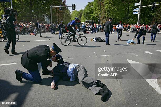 Victims receive first help after a car slammed into a crowd in Apeldoorn on April 30, 2009. Four people died when a car slammed into a crowd at a...