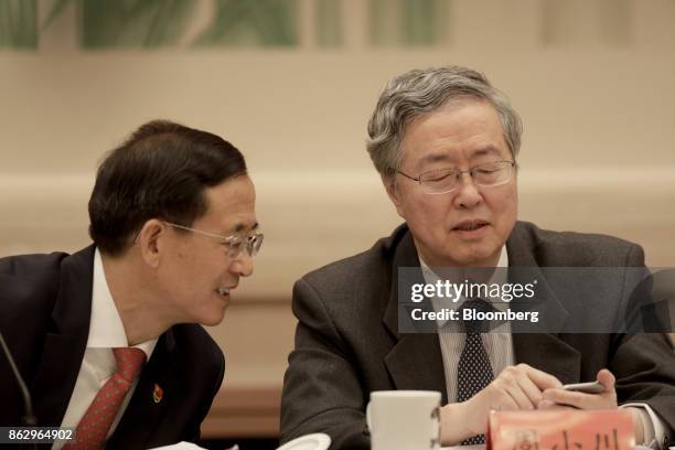 Zhou Xiaochuan, governor of the People's Bank of China , right, speaks with Liu Shiyu, chairman of the China Securities Regulatory Commission, during...