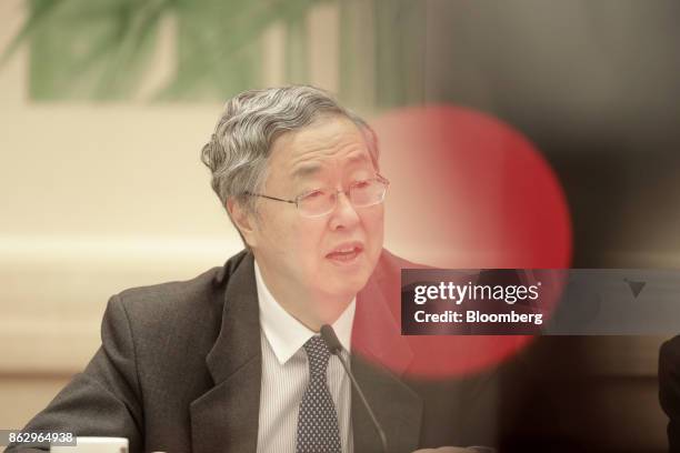 Zhou Xiaochuan, governor of the People's Bank of China , speaks at a news conference at the Great Hall of the People during the 19th National...