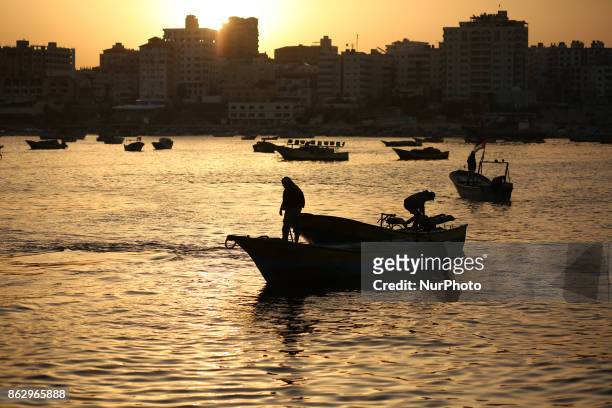 Palestinian fishermen set off for the sea in Gaza City on October 19, 2017 on the first day that fishermen will be allowed by Israel to travel up to...