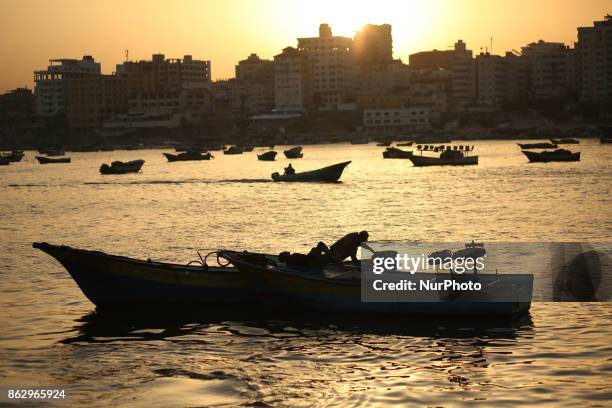 Palestinian fishermen set off for the sea in Gaza City on October 19, 2017 on the first day that fishermen will be allowed by Israel to travel up to...