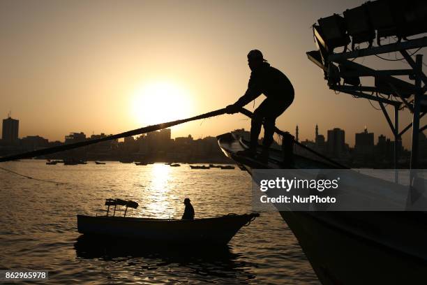 Palestinian fishermen set off for the sea in Gaza City on October 19, 2017 on the first day that fishermen will be allowed by Israel to travel up to...