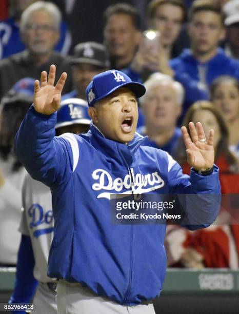 Los Angeles Dodgers manager Dave Roberts disputes a call in the eighth inning in Game 4 of the National League Championship Series against the...