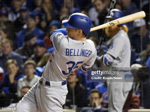 The Los Angeles Dodgers' Cody Bellinger rips a home run against the Chicago Cubs during the third inning in Game 4 of the National League...