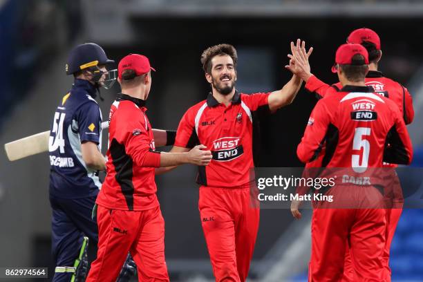 Cameron Valente of the Redbacks celebrates with team mates after taking the wicket of Peter Handscomb of the Bushrangers during the JLT One Day Cup...