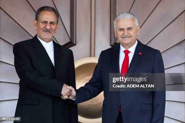 Turkish Prime Minister Binali Yildirim shakes hands with Iranian First Vice President Eshaq Jahangiri prior to their meeting at Cankaya Palace in...