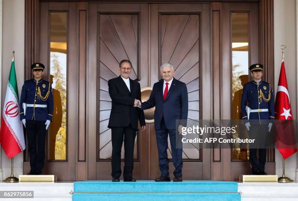 Turkish Prime Minister Binali Yildirim shakes hands with Iranian First Vice President Eshaq Jahangiri prior to their meeting at Cankaya Palace in...