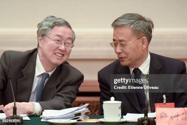 Governor of the People's Bank of China Zhou Xiaochuan and Chairman of the China Banking Regulatory Commission Guo Shuqing talk to each other during a...