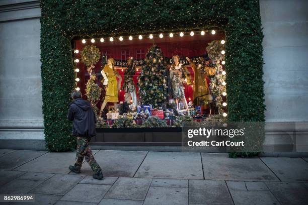 Man walks past a Christmas window display at Selfridges on October 19, 2017 in London, England. Selfridges is the first department store in the world...