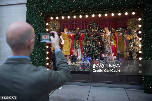 Man photographs a Christmas window display at Selfridges on October 19, 2017 in London, England. Selfridges is the first department store in the...