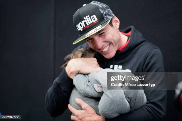 Aleix Espargaro of Spain and Aprilia Racing Team Gresini jokes with kangaroo during the pre-event "MotoGP riders meet the australian animals" during...