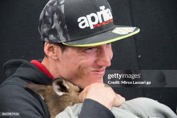 Aleix Espargaro of Spain and Aprilia Racing Team Gresini jokes with kangaroo during the pre-event "MotoGP riders meet the australian animals" during...