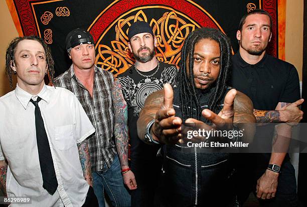Sevendust drummer Morgan Rose, bassist Vince Hornsby, guitarist John Connolly, singer Lajon Witherspoon and guitarist Clint Lowery appear backstage...