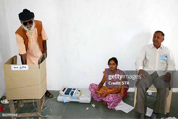 Shri Guru Bharatdasji Darshandasji Maharaj casts his vote at a makeshift cardboard polling booth at Banej, about 20 km from Sasan in Junagadh...