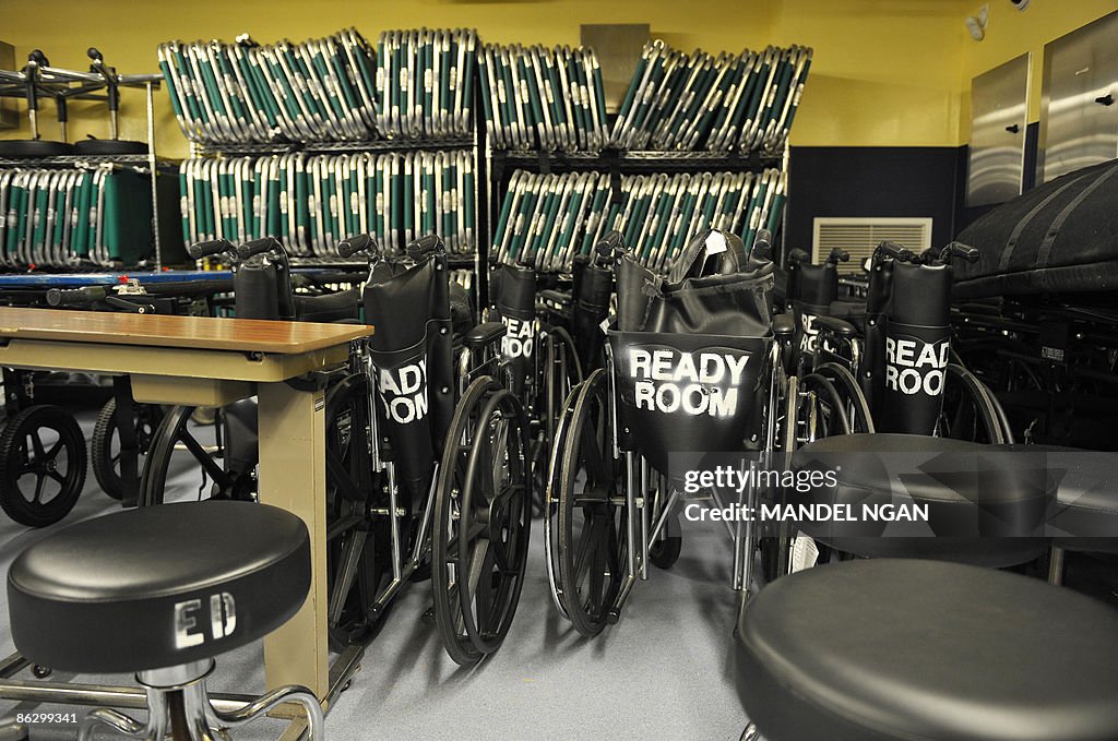 Wheelchairs and folding cots stacked on