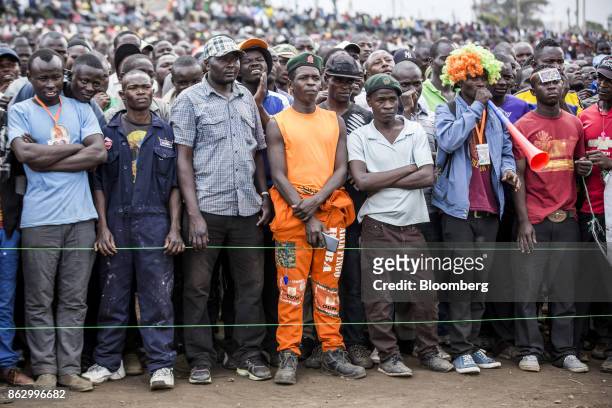Supporters listen to a speech by Raila Odinga, opposition leader for the National Super Alliance , not pictured, during a political rally in Nairobi,...
