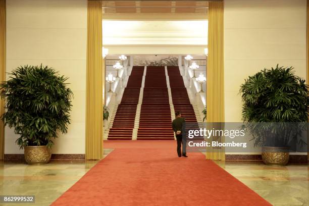 An attendant stands in a hallway in the Great Hall of the People during the 19th National Congress of the Communist Party of China in Beijing, China,...