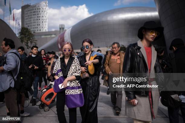 Attendees arrive during Seoul Fashion Week at Dongdaemun Design Plaza in Seoul on October 19, 2017. For Seoul's flamboyant followers of fashion, the...