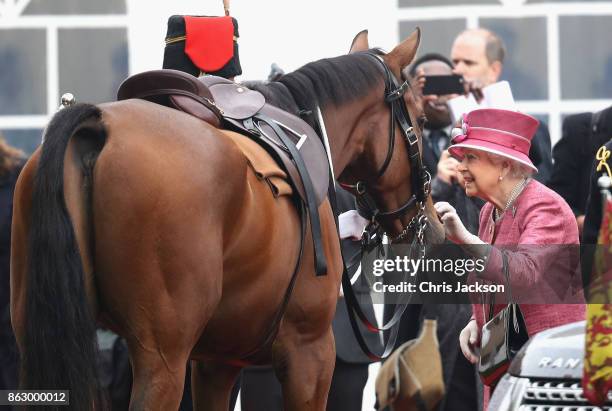 Queen Elizabeth II with her horse called Knock the Brown One as she reviewed the King's Troop Royal Horse Artillery during their 70th anniversary...