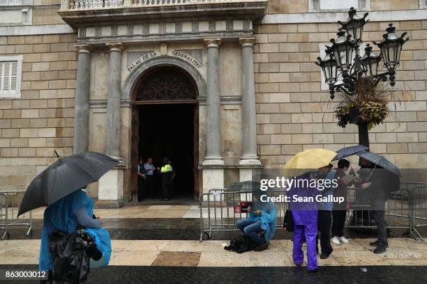 Television journalists wait outside the Palau de la Generalitat de Catalunya, the building that houses the Catalonian presidency, in the hope that...