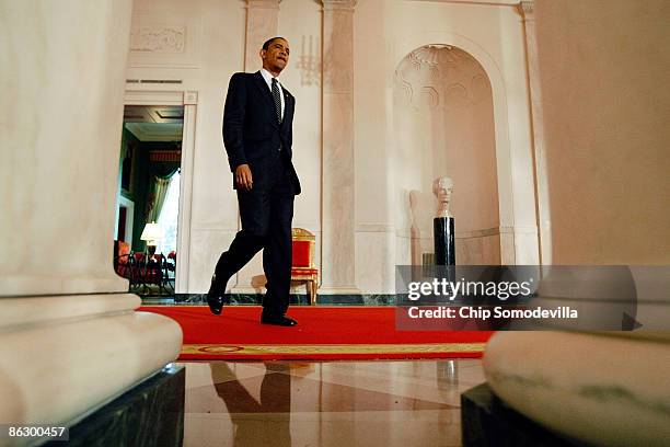 President Barack Obama walks into the foyer of the White House to join members of his auto task force and address the bankruptcy of Chrysler April...