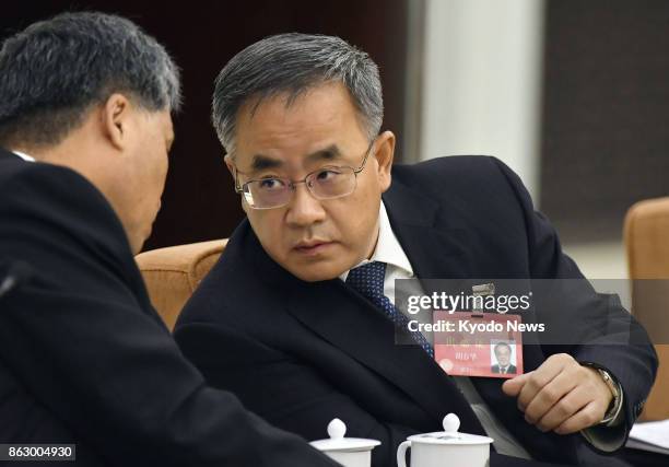 Hu Chunhua , secretary of China's Communist Party in Guangdong Province, attends a group meeting on the sidelines of the national party congress at...