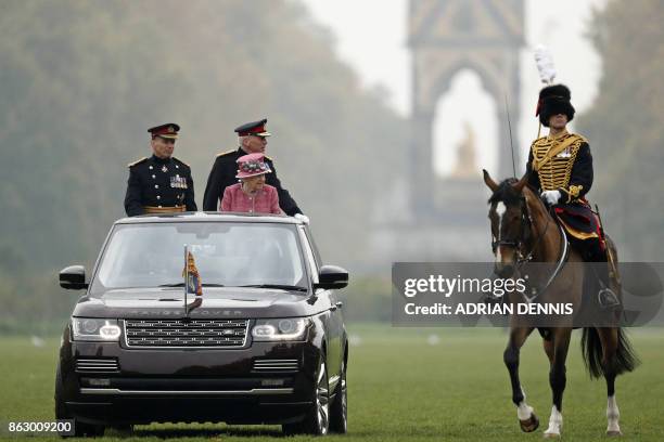 Britain's Queen Elizabeth II reviews The King's Troop Royal Horse Artillery , commonly known as the 'Gunners', during their 70th Anniversary parade...