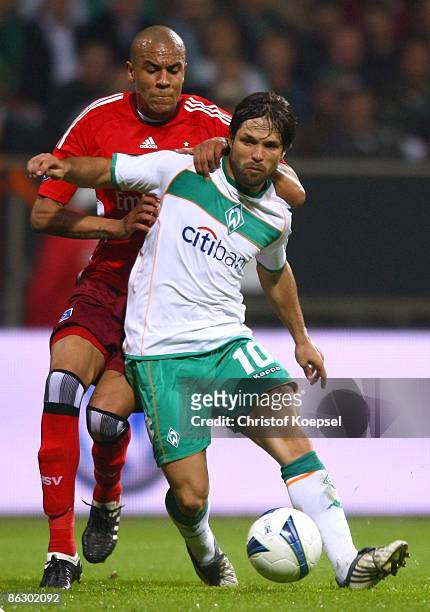 Alex Silva of Hamburg tackles Diego of Werder Bremen during the UEFA Cup Semi Final first leg match between SV Werder Bremen and Hamburger SV at the...