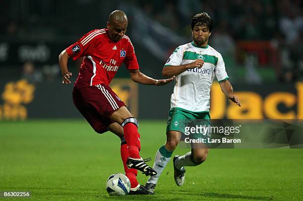 Alex Silva is challenged by Diego of Bremen during the UEFA Cup Semi Final first leg match between SV Werder Bremen and Hamburger SV at the Weser...