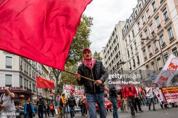 People march behind a banner as thousands gather in the streets of Lyon, France to protest against the labor law at the call of the CGT, the UNEF and...