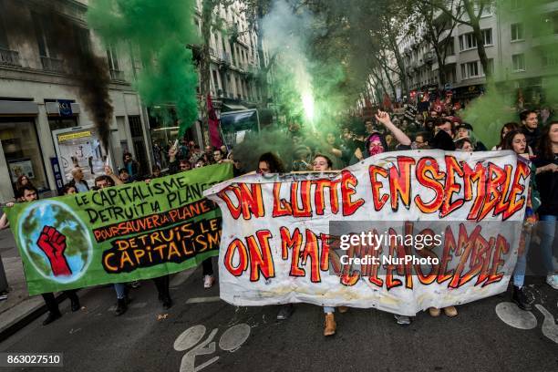 People march behind a banner as thousands gather in the streets of Lyon, France to protest against the labor law at the call of the CGT, the UNEF and...